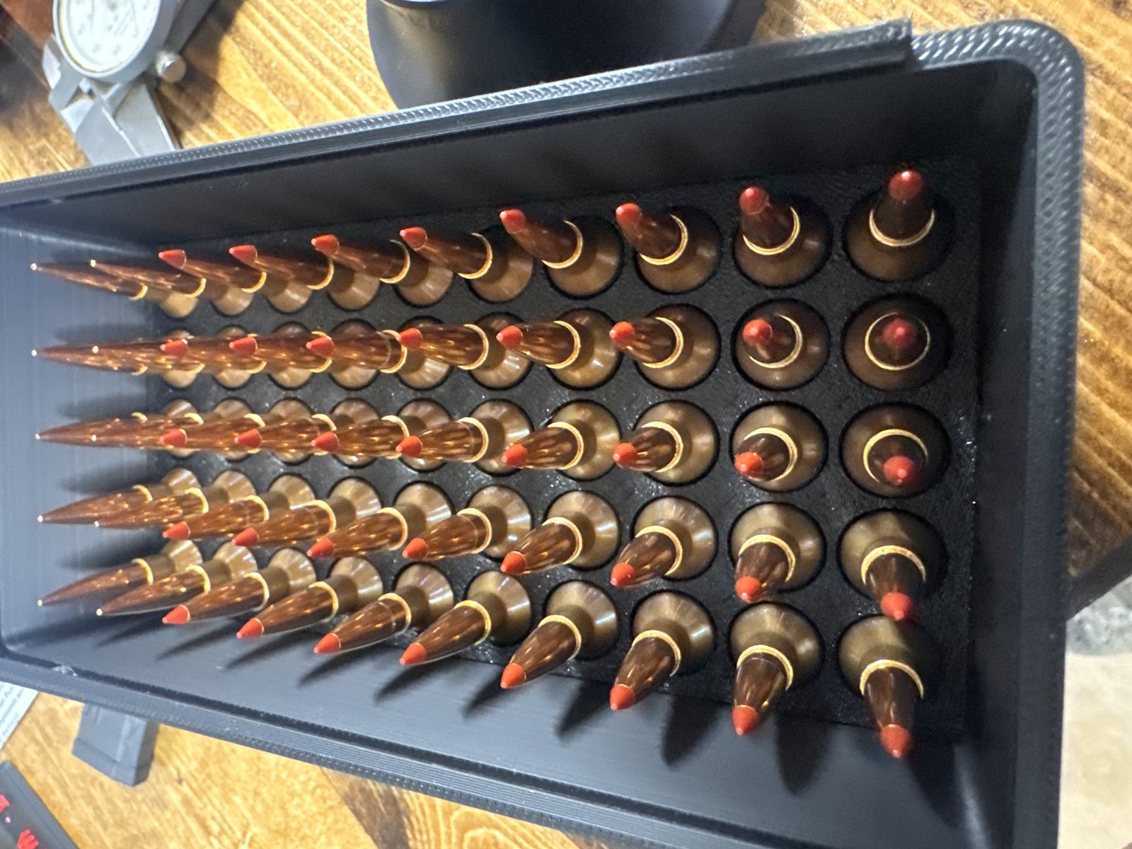 Rifle cartridges loaded in a tray, top down view