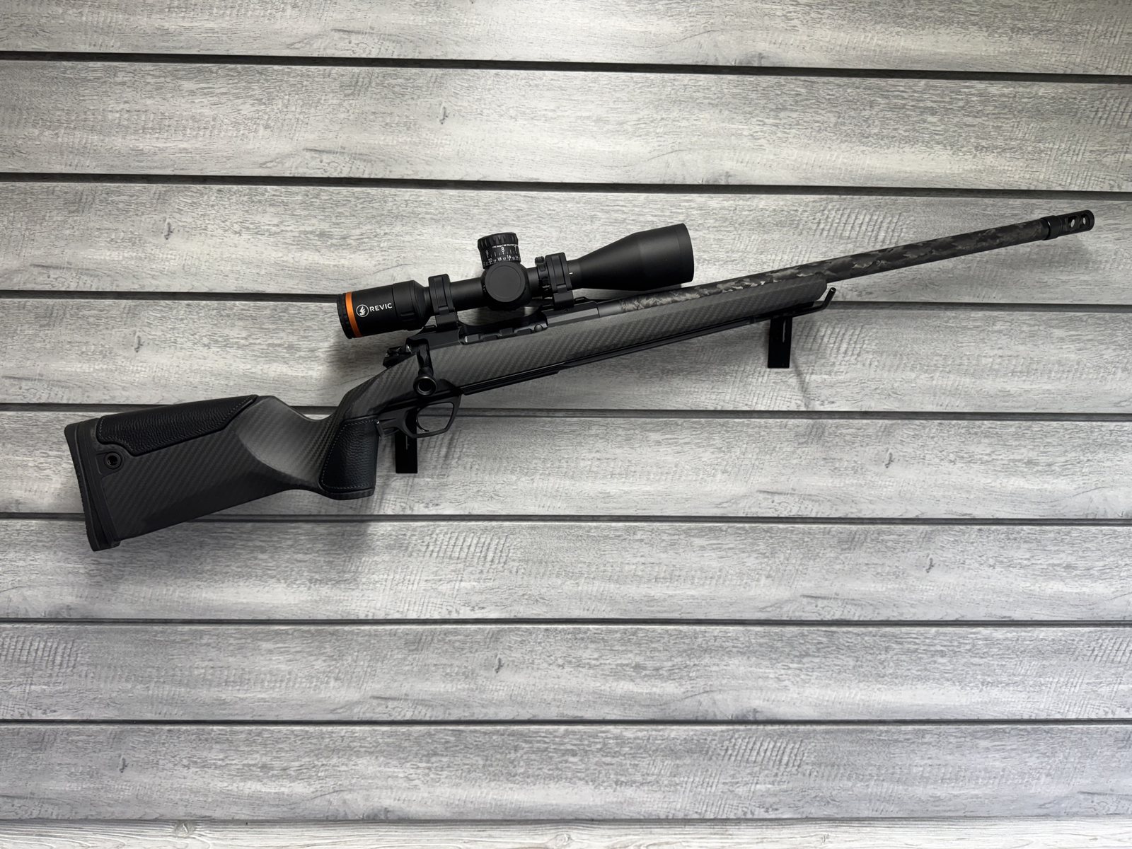 Gunwerks rifle with Revic scope, black carbon fiber stock