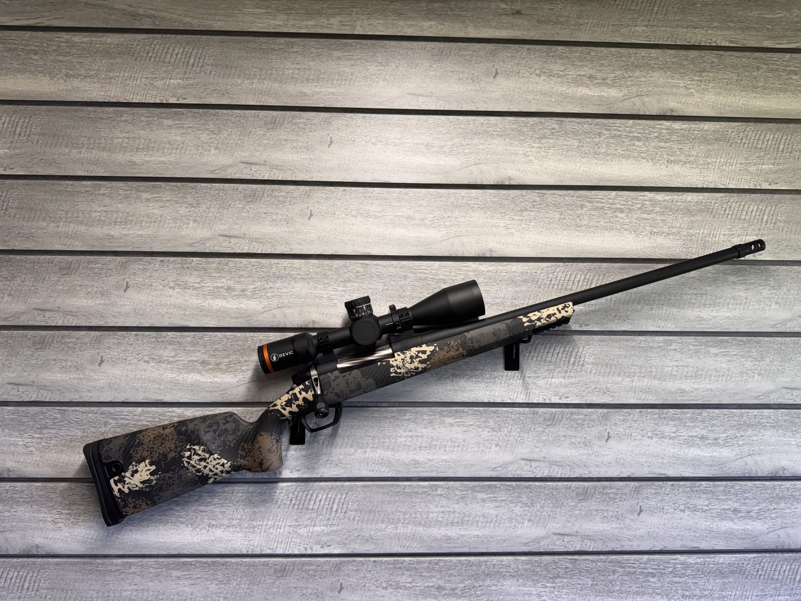 Gunwerks rifle with Revic scope, tan camo carbon fiber stock