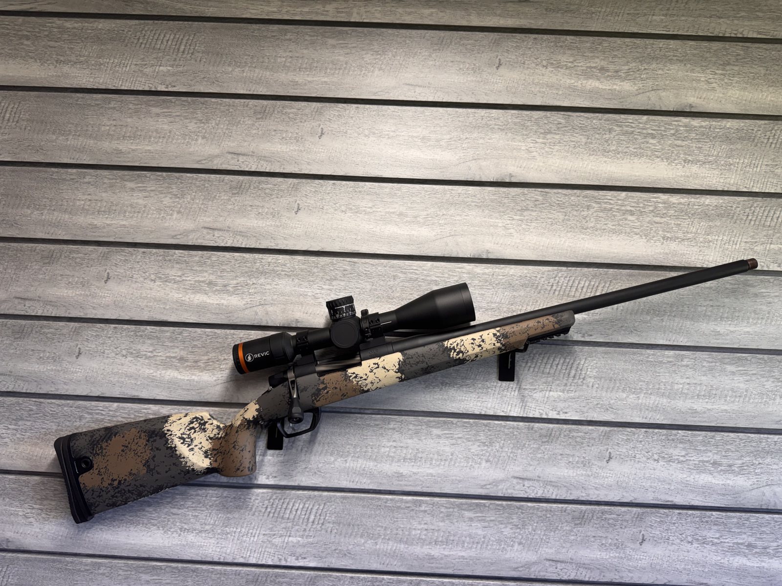 Gunwerks rifle with Revic scope, tan and black camo stock