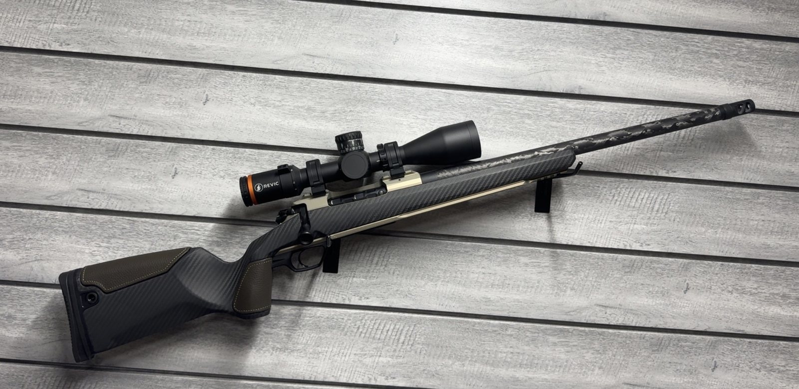 Gunwerks rifle with Revic scope, black and olive stock