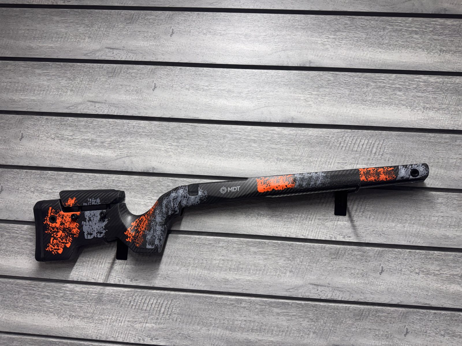 MDT stock, black and orange splatter carbon fiber
