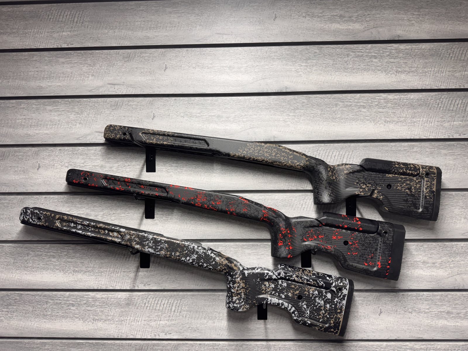 Three MDT stocks, various carbon fiber camo patterns